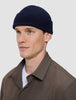 A man wearing a navy blue rib knit Wool Beanie Navy.