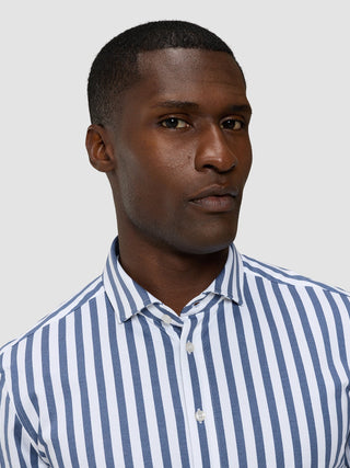 A man wearing a Classic Shirt Dusky Blue Stripe Regular.