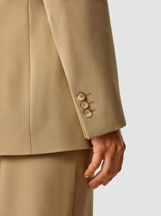Close-up of an Essential Blazer Caramel sleeve featuring three buttons at the cuff.