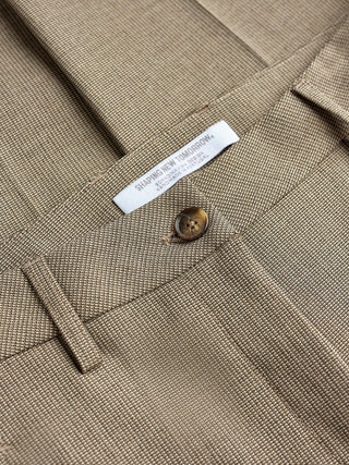 Close-up of beige Essential Pants Straight Latte with a Shaping New Tomorrow brand label and a button at the waist.