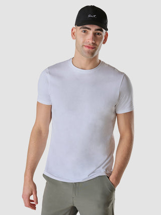 A man wearing an Essential Cap Legacy Black and a plain white t-shirt.
