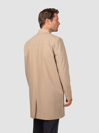 A man seen from behind wearing a Waterproof Trench Coat Sand Grain.