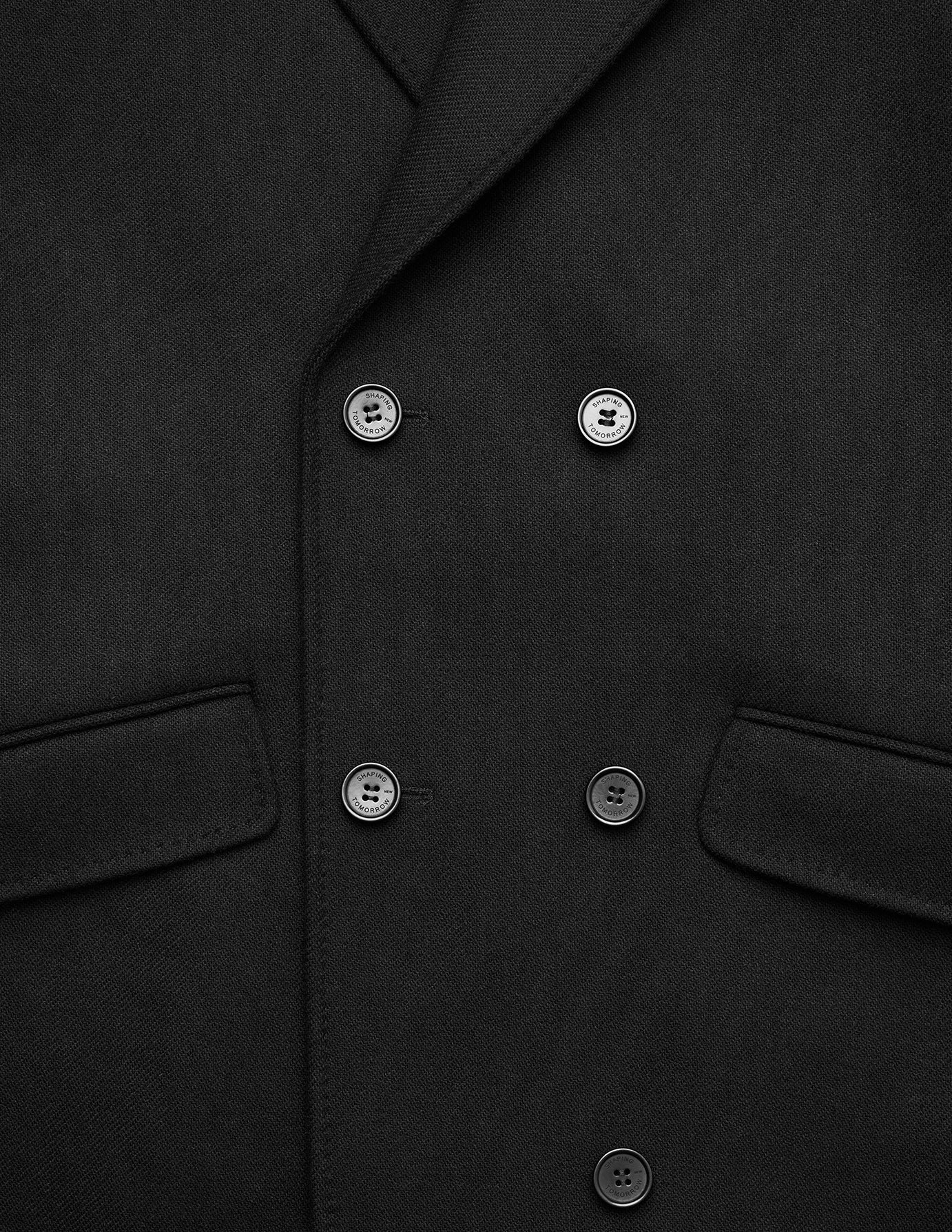 Women’s Wool Coat Black in a Scandinavian design with a double-breasted front, four visible buttons, and two flap pockets.