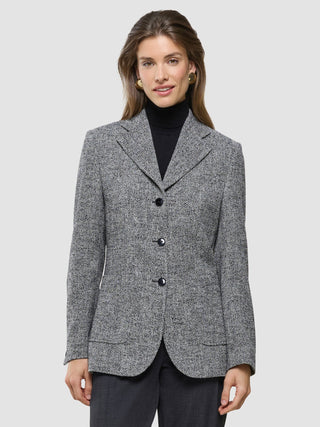 A woman wearing a black turtleneck under the Women Ashryn Blazer Domino Herringbone.