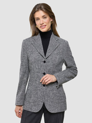 A woman wearing a Women Ashryn Blazer Domino Herringbone over a black turtleneck.