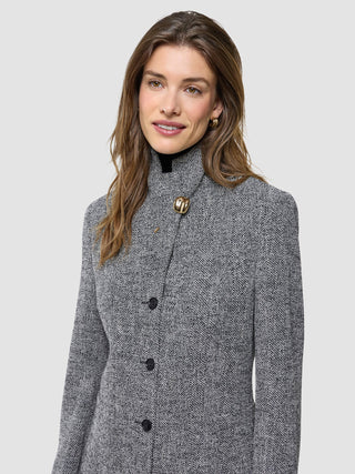 A woman wearing a Women Ashryn Blazer Domino Herringbone with a prominent gold button at the collar and a rich bouclé texture.