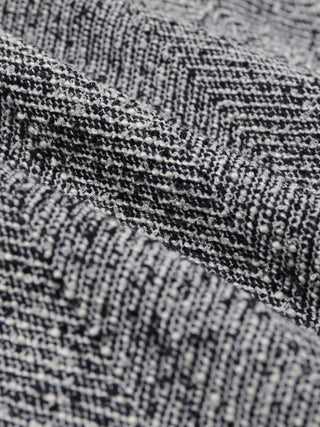 A close-up of the Women Ashryn Short Skirt Domino Herringbone featuring a textured herringbone weave.