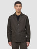 A man wears the Atelier Overshirt Dark Brown, a heavyweight textured blazer featuring three front buttons and two large patch pockets.