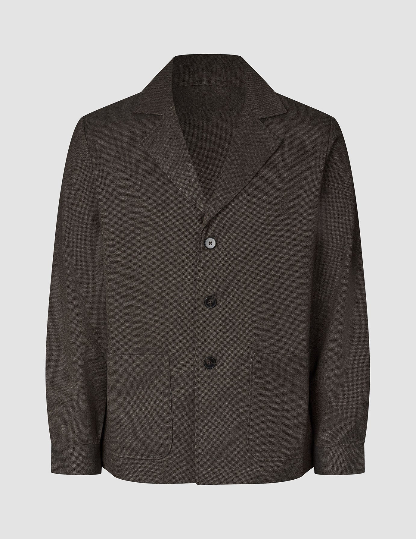 Atelier Overshirt in dark brown, a button-front blazer in heavyweight textured fabric featuring a notched lapel and two front patch pockets.