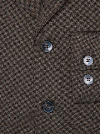 Close-up of the dark brown Atelier Overshirt in a heavyweight textured fabric, featuring two front buttons and two matching buttons on the sleeve cuff.