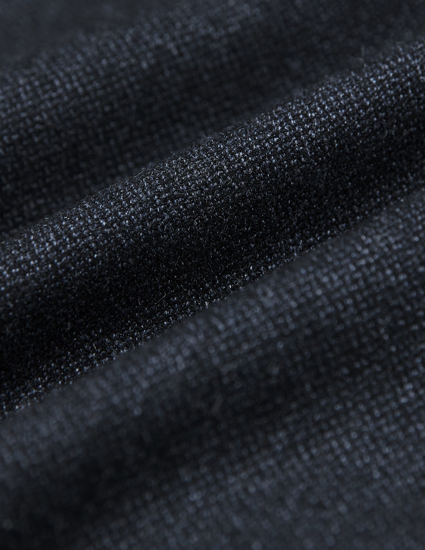 Close-up of the Atelier Overshirt Dark Navy, featuring a heavyweight, textured woven surface in a dark navy hue with soft folds.