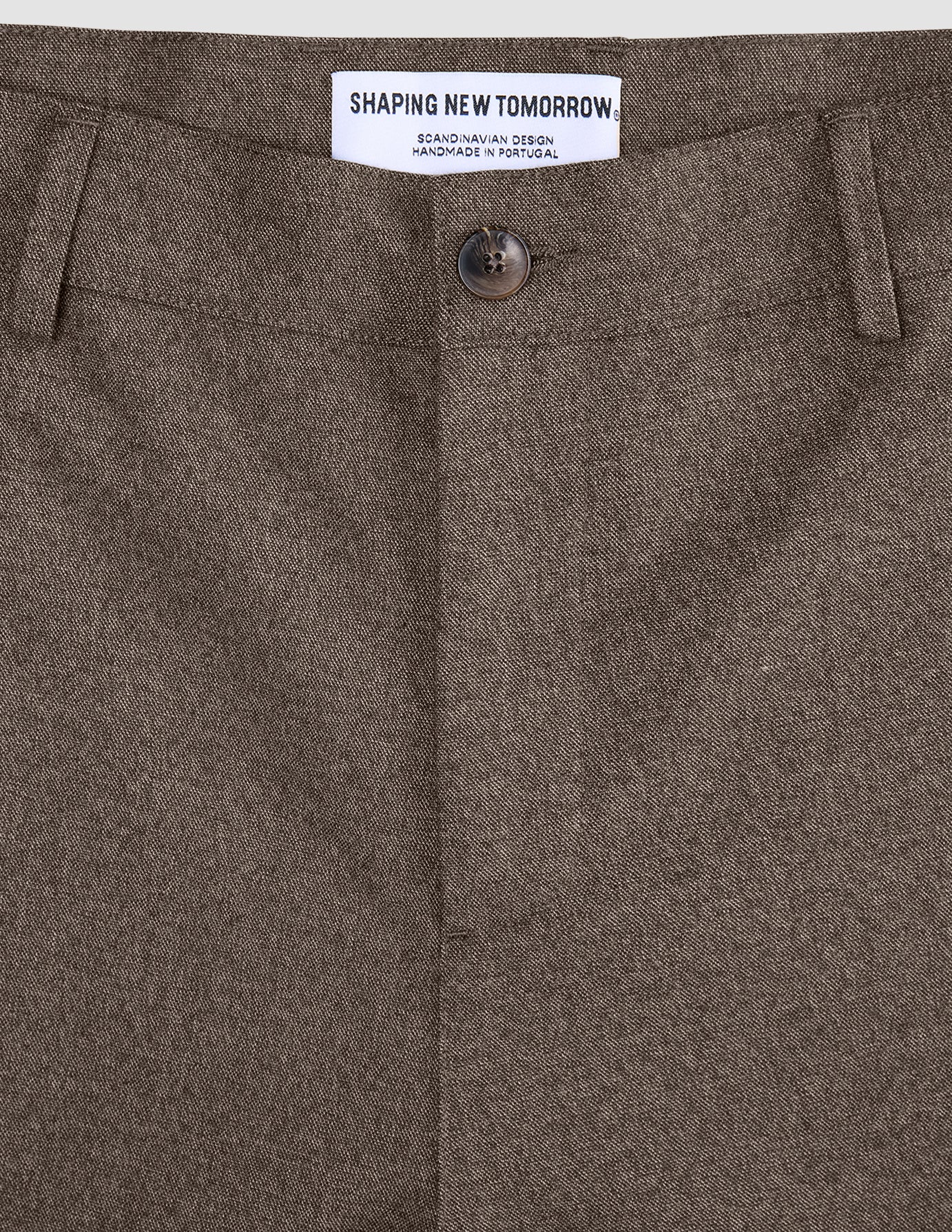 Close-up of the button fly and waistband on Atelier Pants Relaxed Dark Beige in heavyweight broken twill, featuring an internal brand label and minimalist Scandinavian design.