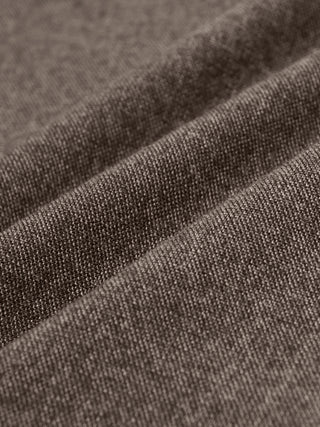 Close-up of the Atelier Pants Relaxed Dark Beige, showing folded heavyweight fabric in a dark beige broken twill with a visible woven texture.