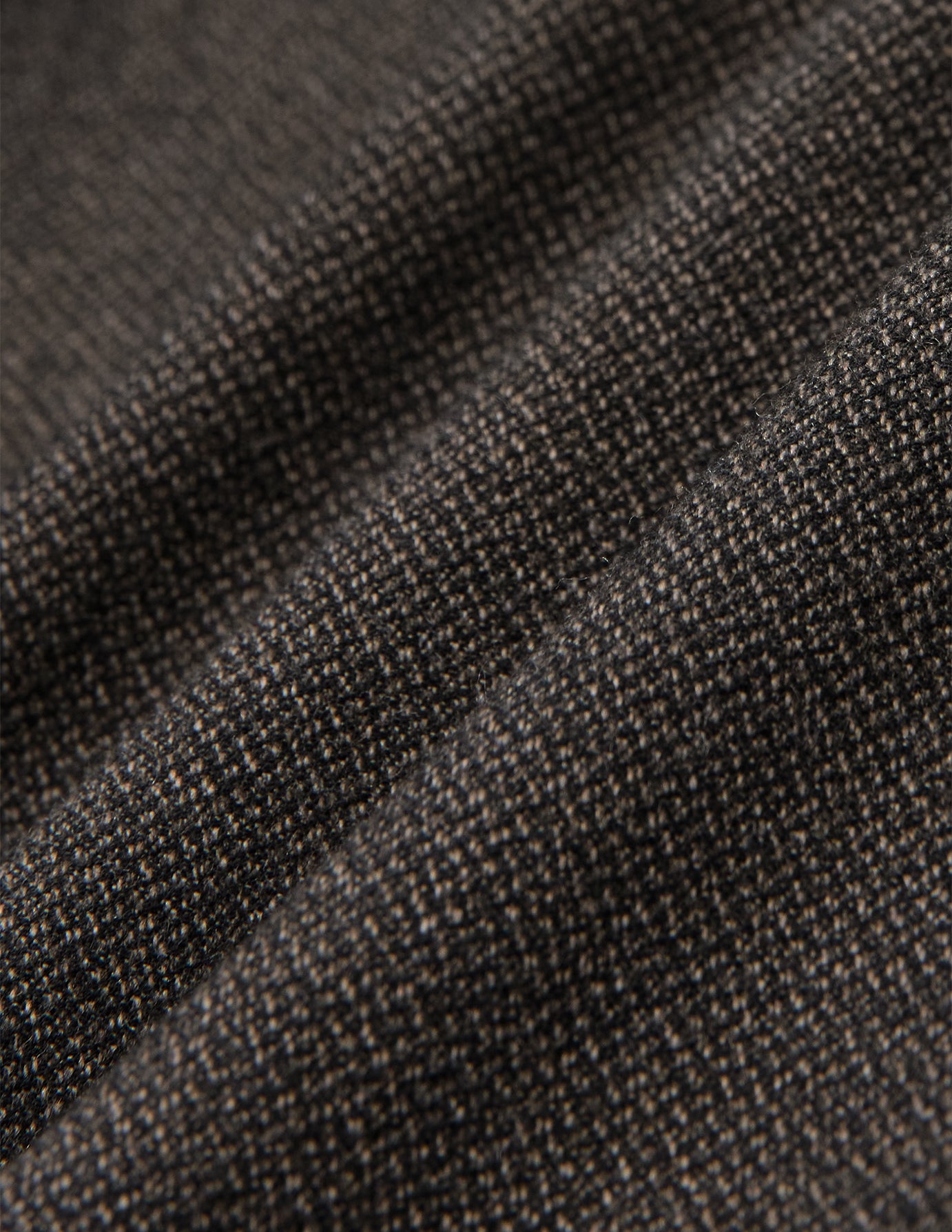 Close-up of folded dark brown Atelier Pants Relaxed Dark Brown fabric with a textured, heavyweight broken twill pattern.