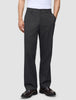 A person wearing dark grey Atelier Pants Relaxed in heavyweight broken twill paired with dark leather loafers.