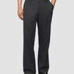 A person wearing dark grey Atelier Pants Relaxed in heavyweight broken twill paired with dark leather loafers.