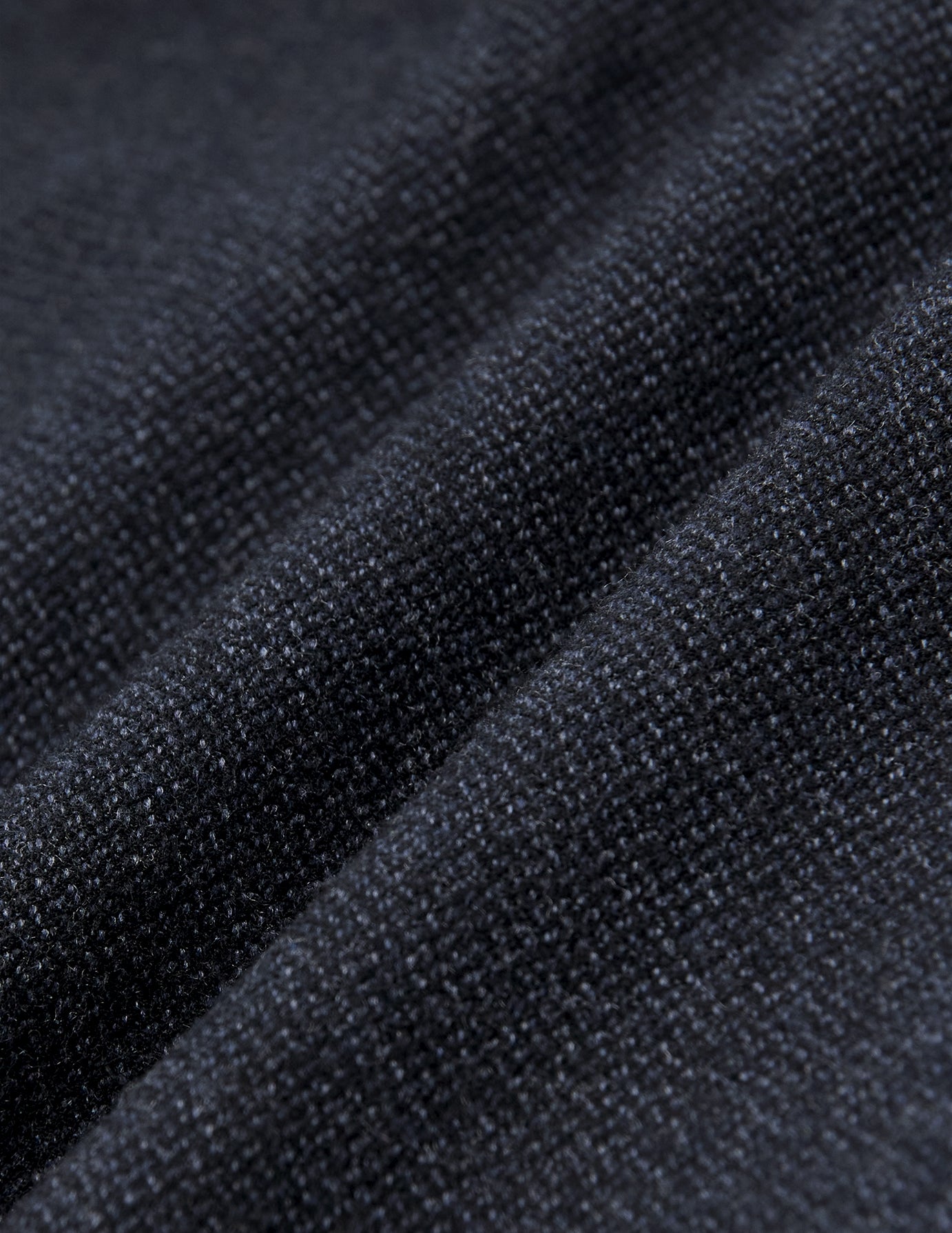 Close-up of dark navy blue heavyweight broken twill fabric from the Atelier Pants Relaxed Dark Navy, featuring a textured, knit-like weave shown in soft folds.