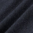 Close-up of dark navy blue heavyweight broken twill fabric from the Atelier Pants Relaxed Dark Navy, featuring a textured, knit-like weave shown in soft folds.