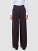 Women’s Avira Pants Wide Burgundy Berry featuring a high-waisted, wide-fit silhouette paired with a white button-down shirt.