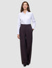 A woman wearing a crisp white button-down shirt tucked into Women’s Avira Pants Wide Burgundy Berry.