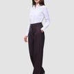 A woman wears a white button-down shirt tucked into high-waisted, wide-fit Women’s Avira Pants Wide Burgundy Berry.