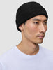 A person wearing a black rib knit Beanie Black.