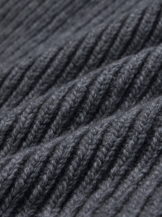 Close-up of a Beanie Dark Grey in merino wool with a rib knit and folded texture.