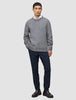 A man wearing a Chunky Soft Wool Knit Crewneck Glacier Grey sweater over a white collared shirt, dark trousers, and dark loafers.