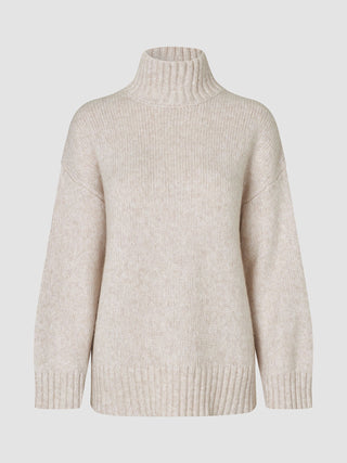 Women’s Chunky Soft Wool Knit Turtleneck Sugar Melange in beige, featuring a chunky wool knit, turtleneck, and ribbed cuffs and hem.