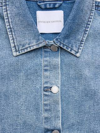 A Women’s Classic Denim Jacket Snow Blue Wash with the Shaping New Tomorrow brand label on the inside collar and branded metal buttons down the front.