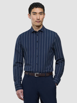 A man wearing a Classic Shirt Midnight Pinstripes Regular and dark trousers.