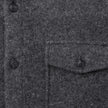 Close-up of a Double Layer Wool Overshirt Regular Dark Grey featuring a buttoned placket and a single chest pocket with a matching button.