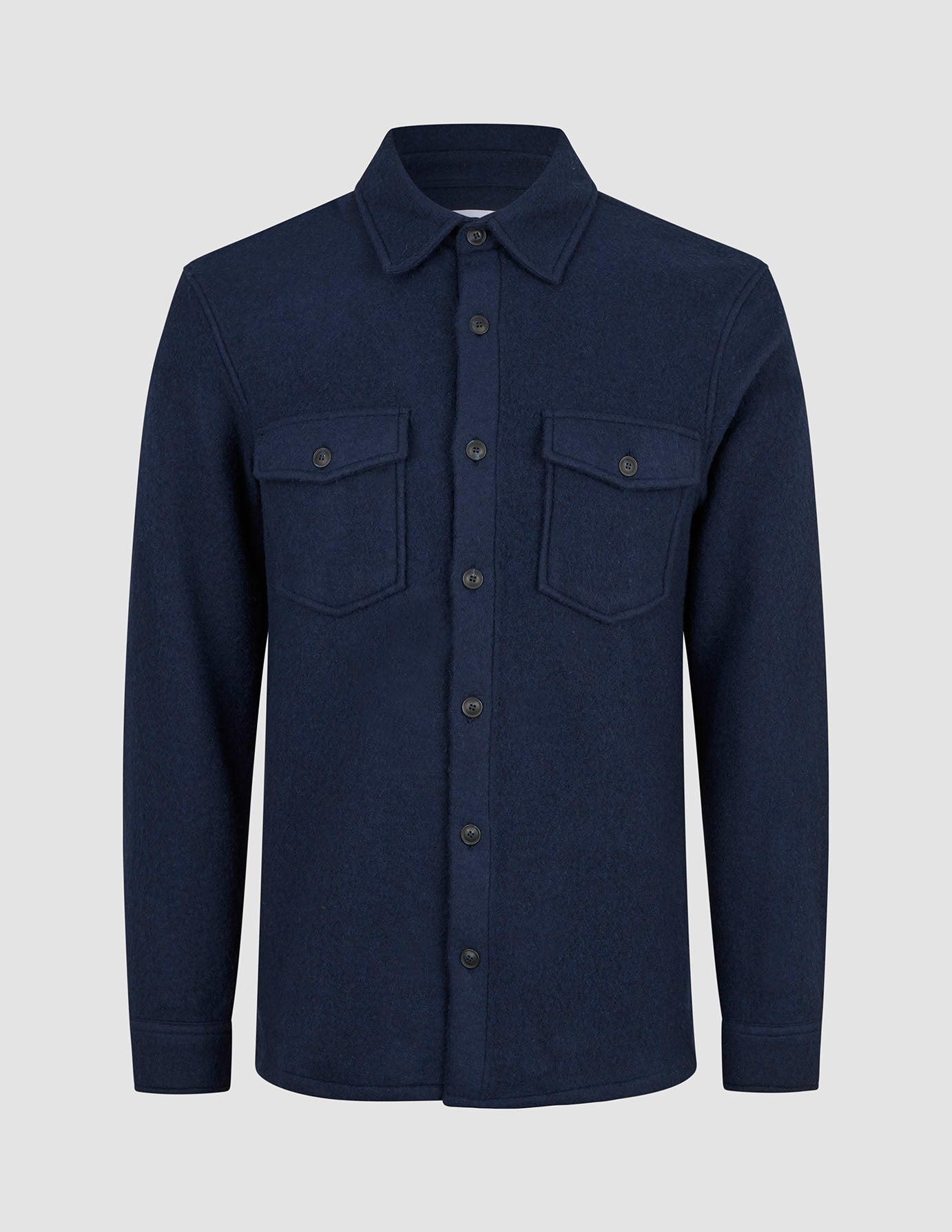 Dark navy Double Layer Wool Overshirt Regular Dark Navy featuring a collar, two chest pockets, and a long-sleeved double-layer wool design reflecting minimalist Scandinavian style.