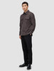 A person wearing a Double Layer Wool Overshirt Saddle Brown with two chest pockets, black trousers, and black loafers.