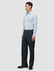 A man wearing an Elevated Shirt Regular Classic Blue Striped light blue striped Pima cotton shirt, dark trousers, and black dress shoes.