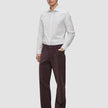 A man wearing an Elevated Shirt Regular Light Grey Striped long-sleeve dress shirt, dark brown trousers, and dark loafers.