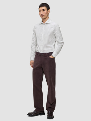 A man wearing an Elevated Shirt Regular Light Grey Striped long-sleeve dress shirt, dark brown trousers, and dark loafers.