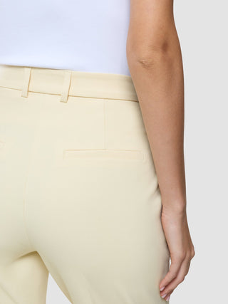 Close-up view of Women Essential Pants Tapered Misty Yellow featuring belt loops and a welt pocket.