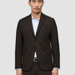 A man wears a Motion Blazer Regular Cognac in dark brown over a white dress shirt.