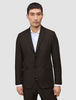 A man wearing a Motion Blazer Regular Cognac, a tailored, dark brown two-button blazer with 360° stretch over a white collared shirt.