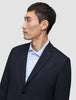 A man in profile wears a Motion Blazer Slim Midnight Blue over a light blue pinstriped button-down shirt.