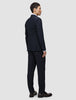 A man seen from behind wearing the navy Motion Blazer Slim Midnight Blue and matching trousers.