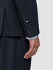 Close-up of a Motion Blazer Slim Midnight Blue sleeve featuring 360° stretch, four cuff buttons, and a white striped shirt sleeve showing underneath.