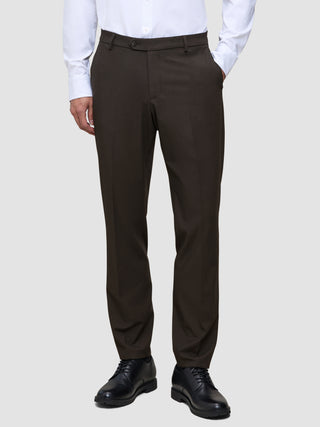 A person wearing lightweight, 360° stretch Motion Suit Pants Regular Cognac, a white button-down shirt, and black dress shoes.