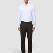 A man wearing a white button-down shirt, Motion Suit Pants Regular Cognac, and black dress shoes.