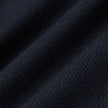 Close-up of Motion Suit Pants Regular Midnight Blue featuring lightweight, dark blue fabric with a visible, breathable woven texture and subtle folds.