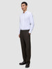 A man wearing a white button-down shirt, dark loafers, and Motion Suit Pants Relaxed Cognac.