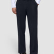 A person wearing a white button-down shirt tucked into Motion Suit Pants Relaxed Midnight Blue and brown leather loafers.