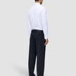 A person seen from behind wearing a white button-down shirt and Midnight Blue Motion Suit Pants Relaxed.