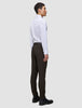A man in profile wears a white dress shirt, slim-fit Motion Suit Pants Slim Cognac, and black leather boots.